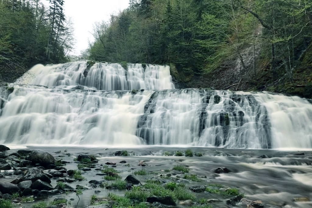 A large waterfall surrounded by trees