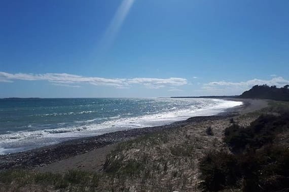 A rocky beach under a blue sky