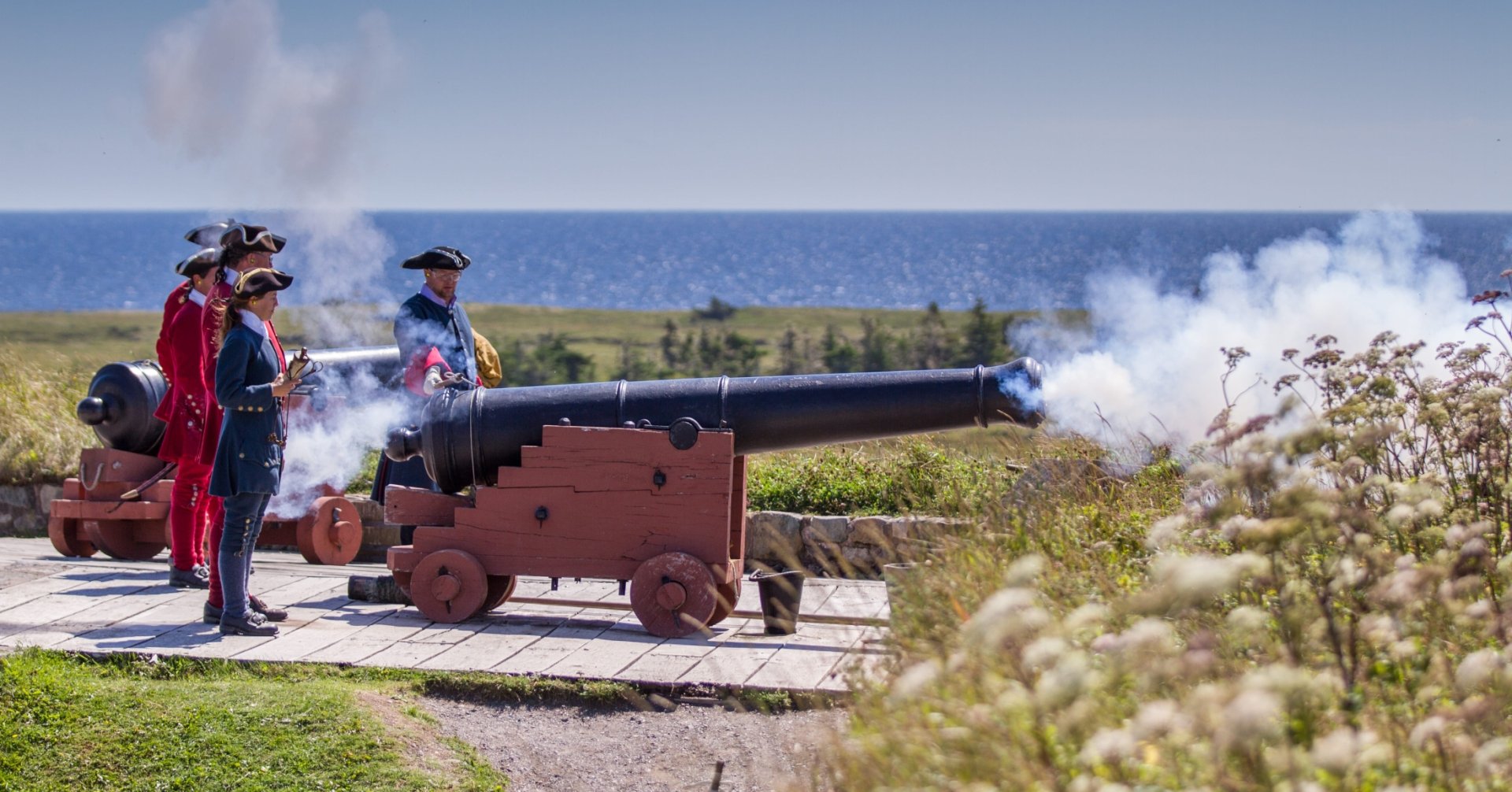 Men in period clothes set off a cannon