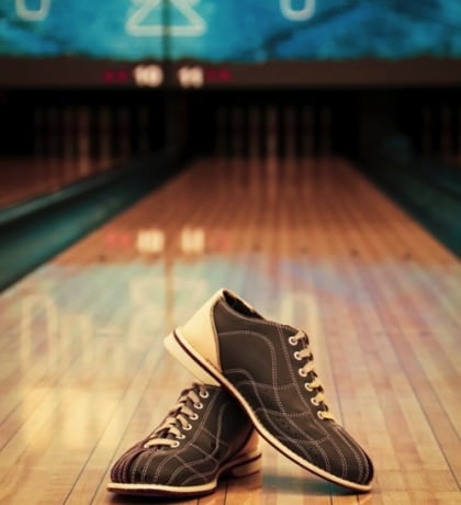 two bowling shoes on a bowling alley lane