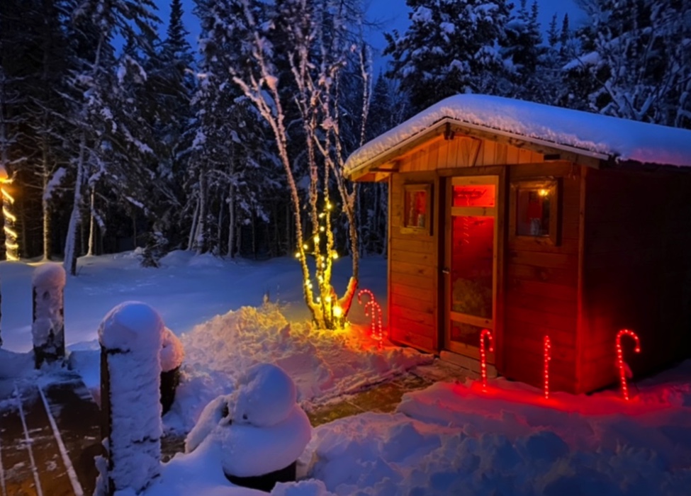 exterior of wooden cabin sauna in winter at night